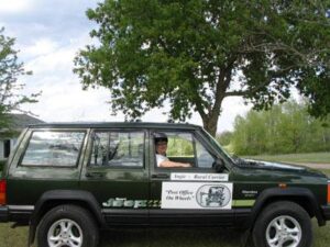 Rural letter carrier Angeline Dunn with her RHD Cherokee postal delivery vehicle