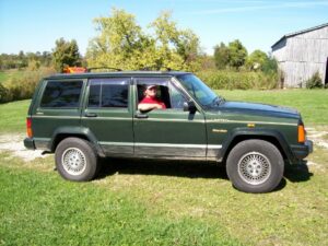 Rural letter carrier Anna Johnson with her RHD Jeep Cherokee