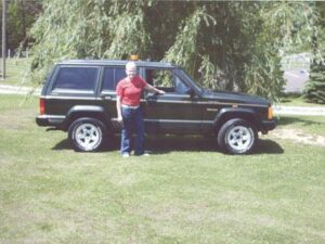 Rural letter carrier Annette Isenberg with her RHD Jeep Cherokee