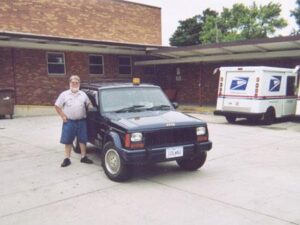 Rural letter carrier Bill Farley with his RHD Cherokee