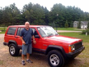 Rural letter carrier Brian Pertuset and his RHD Cherokee