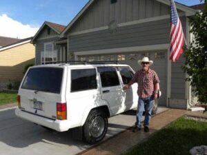 Rural postal worker (RCA), Chuck Reed, with his RHD Cherokee