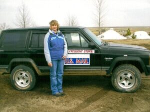 Rural letter carrier Connie Roehrich with her RHD Jeep Cherokee