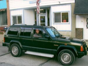 Rural letter carrier Deb Kuhlmann with her RHD Cherokee