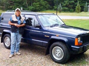 Rural letter carrier Diane Denny with her Jeep Cherokee
