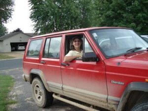 Rural letter carrier Diane Shursen with her RHD Jeep Cherokee