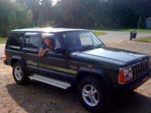 Rural letter carrier Dianna Eperthener driving her RHD Cherokee postal delivery vehicle