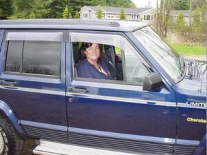 US rural mail carrier Donna Spitzley driving her RHD Jeep Cherokee