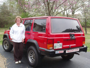 Rural letter carrier Frances Deland and her RHD Jeep Cherokee postal delivery vehicle