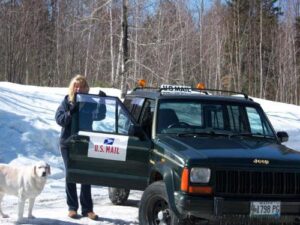 Rural letter carrier Ginny Libby and her dog with her RHD Cherokee