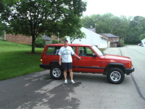 Rural letter carrier Herman Fausnaugh and his RHD Cherokee