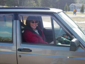 Rural letter carrier Jeanne Aslakson driving her RHD Jeep Cherokee