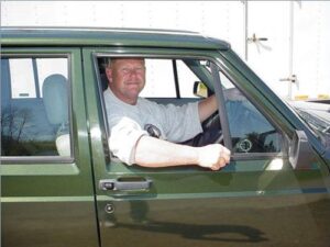 Rural letter carrier Jeff Barnes driving his RHD Jeep Cherokee