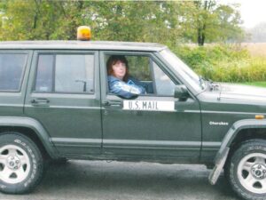Rural letter carrier Jennifer Hamilton driving her RHD Cherokee