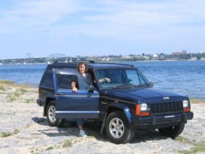 Rural letter carrier Jill Swanson with her RHD Jeep Cherokee