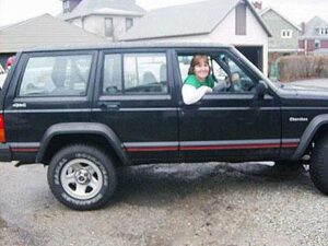 Rural letter carrier Julie Lewis driving her RHD Jeep Cherokee