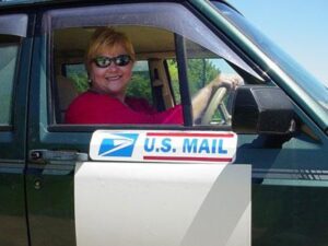Rural letter carrier Karen Howell driving her RHD Cherokee