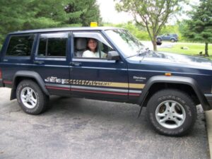 Rural letter carrier Karen Swafford driving her RHD Cherokee