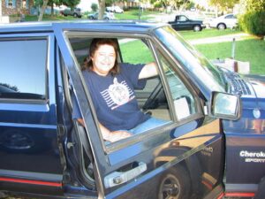 Rural letter carrier Laura Ashby in her RHD Cherokee
