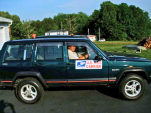 Rural letter carrier Luther Shelton driving his RHD Jeep Cherokee