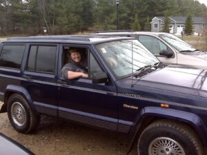 Rural letter carrier Mary Palmer driving her RHD Jeep Cherokee postal delivery vehicle