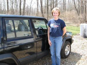 Rural letter carrier Muriel Wilson with her right-hand drive Cherokee