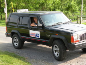 Rural letter carrier Nancy Dresch driving her RHD Jeep Cherokee