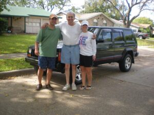Nick Hantes with his rural letter carrier dad and the RHD Jeep Cherokee he gave him