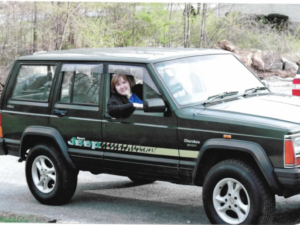 Rural letter carrier Penny Clausi driving her RHD Cherokee