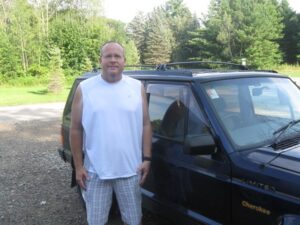 Rural letter carrier Philip Funk with his RHD Cherokee