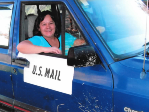 Rural letter carrier Renee Dove driving her RHD Jeep Cherokee
