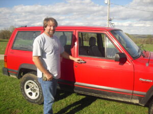 Rural letter carrier Ricky Burden and his RHD Cherokee.