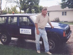 Rural letter carrier Robert Moul with his RHD Jeep Cherokee mail delivery vehicle