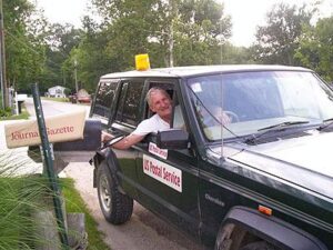 Rural postal carrier Robert Schemm delivering mail from his RHD Jeep Cherokee