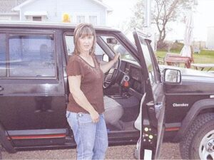 Rural letter carrier Robin Brockman with her RHD Jeep Cherokee postal delivery vehicle