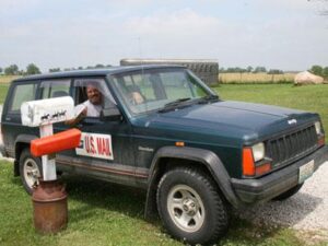 Rural letter carrier Roger Crawford delivering mail from the right with his RHD Jeep Cherokee