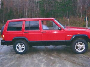 Rural letter carrier Roger Merrill driving his RHD Jeep Cherokee