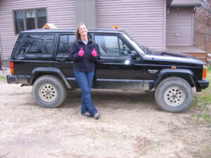 Rural letter carrier Sandra Martin with her RHD Cherokee mail delivery vehicle