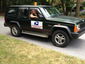 Rural letter carrier Sheri Lehn driving her right-hand drive Jeep Cherokee