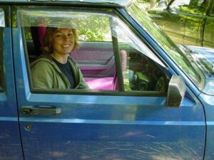 Rural letter carrier Sue Croy driving her right-hand drive Jeep Cherokee postal delivery vehicle