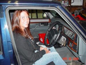 Rural letter carrier Tammy Lovings in the right side drivers seat of her RHD Jeep Cherokee