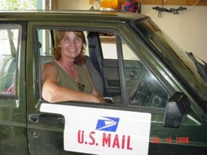 Rural letter carrier Teresa Bristow driving her RHD Jeep Cherokee