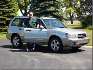 Rural letter carrier Thomas Kirk with his RHD Subaru Forester postal delivery vehicle