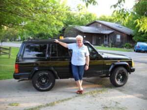 Rural letter carrier Vicki Berglund with her RHD Jeep Cherokee