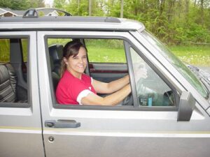 Rural letter carrier Wanda Broussard driving her right-hand drive Jeep Cherokee
