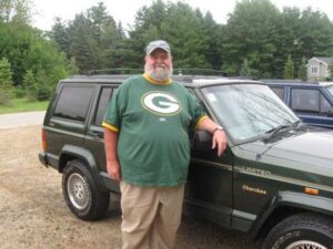 Rural carrier William Deeds with his RHD Cherokee