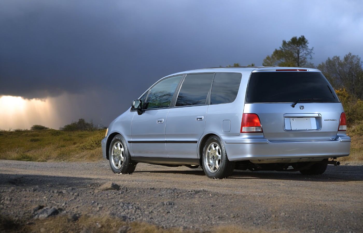 Right hand drive Honda Odyssey mini van in silver from left rear
