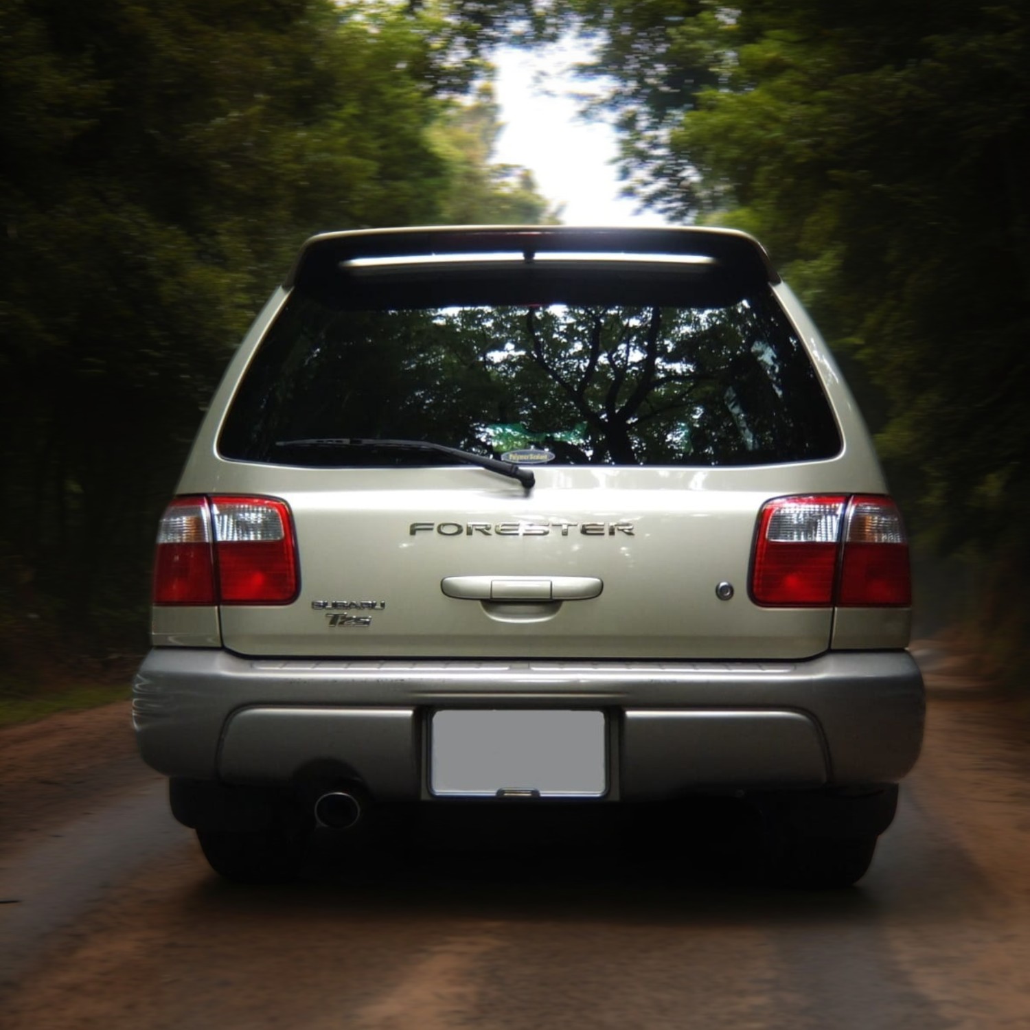 RHD Subaru Forester in champagne from rear