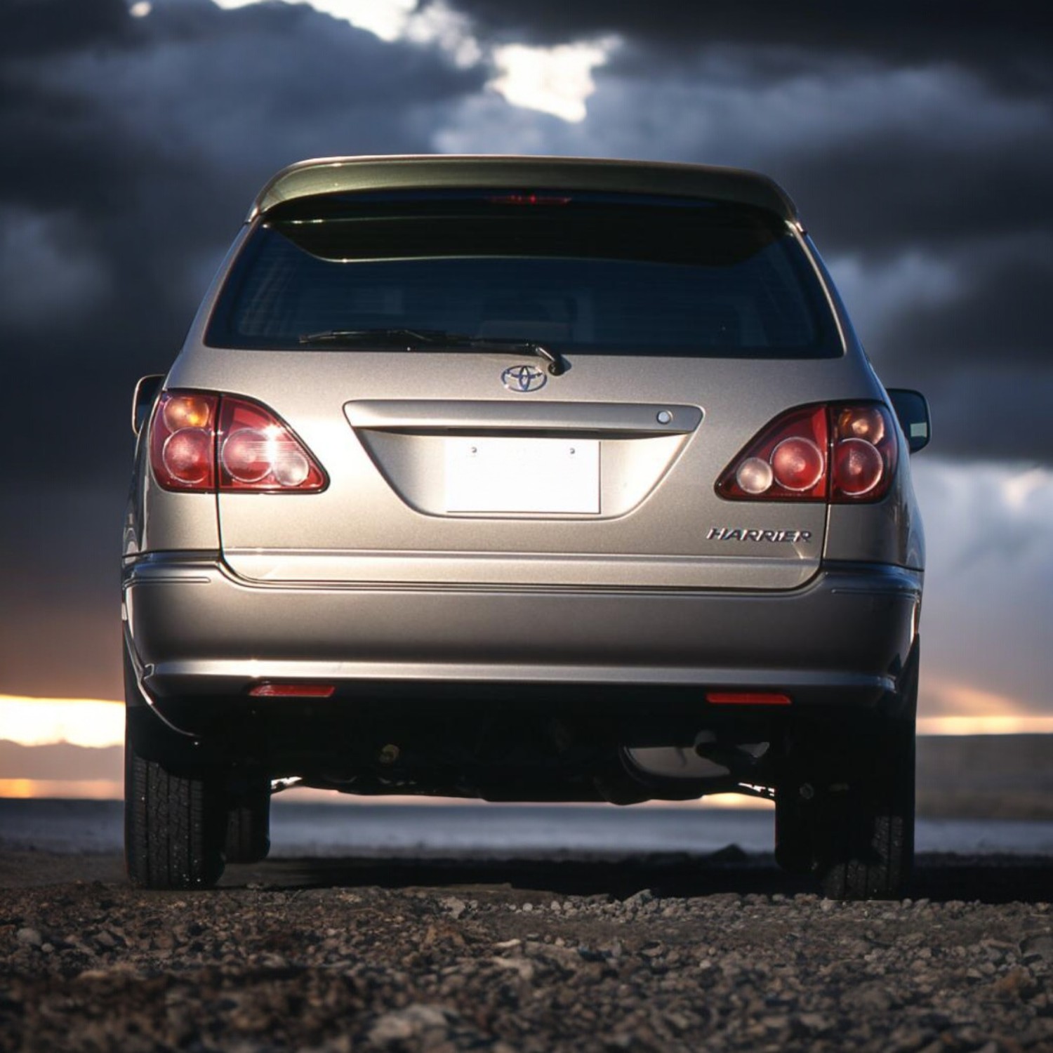 RHD Toyota Harrier (Lexus RX) SUV in champagne silver from rear.
